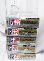 Photo showing four sealed boxes of PGA Tour Pro Set Special Inaugural Set cards stacked vertically, each labeled as 100 PGA Tour Cards with Special Inaugural Set text.