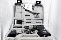 Open hard case showing Ryobi cordless drill, battery charger, battery pack, and drill bits placed in the lid compartments.
