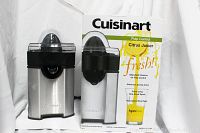 Front and side view of the Cuisinart juicer next to its original box showing branding and features.