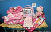 Full set of Hello Kitty items including robe, pajama bottoms, PEZ dispensers in packaging, puffy stickers, and TY Beanie Baby plush
