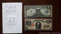 Front sides of two US $1 banknotes: 1899 Silver Certificate on top and 1917 United States Note below.