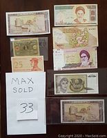 Photo showing a variety of old foreign banknotes including some from Iran, Indonesia and Lebanon, with various denominations and designs.