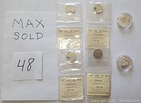 Four graded Canadian $25 coins in colour and two Canadian $10 fine silver coins displayed, each in protective packaging showing grading and certification labels for the $25 coins, and clear capsules for the $10 coins.