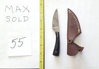 Photo shows one Damascus steel straight knife with a polished dark buffalo horn handle and brass rivets, accompanied by a brown leather sheath with stitched edging and snap closure, alongside a measurement scale showing the knife approximately 8 inches long.