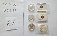Three silver coins in individual capsules with certificates, MaxSold sign