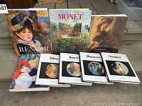 Photo showing the front covers of all art books in the lot, including Renoir, Monet, Rembrandt, and smaller Master Artists Library editions Dürer, Bosch, Masaccio, Vermeer.