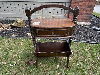 Full view of the antique wooden sewing and knitting table featuring a drawer and a lower section for storage.