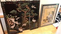 Four-panel lacquered Asian folding screen with cranes and nature motifs, shown with minor corner damage to one panel.