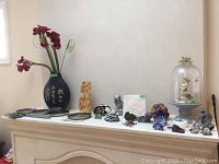 Wide view of white mantel displaying all items