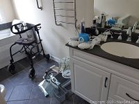 Nexus walker near window, glass bathroom scales, white wired items on counter