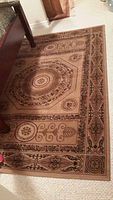 Top view of the Everest high density Prado area rug with intricate circular and floral motifs and ornamental borders in brown and beige.