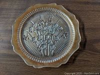 Photo of the front side of one iridescent Iris and herringbone pattern depression glass dinner plate with scalloped and textured edges and floral motif in center.