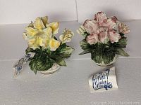 Two vintage Capodimonte porcelain flower sculptures together with original hang tags and boxes.