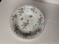 Top view of large bowl showing detailed floral chintz pattern with pink, yellow, and blue flowers.