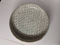 Top view of the bowl showing the intricate filigree pattern inside with small dark motifs covering the surface.