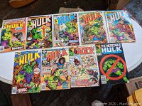 Overview of nine Marvel comic books featuring The Incredible Hulk and Marvel Super Heroes, laid out on a white table showing various colorful action covers.