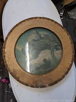 Circular frame with print of three horses, showing top-down view and overall condition.