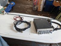 Complete Cobra 29 NW LTD Classic CB radio setup including radio unit, connected microphone, antenna cable, power cable, and full-length antenna on white table.