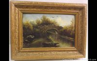 Frontal view of painting within carved gold gilt wood frame showing stone bridge scene