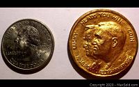 Photo showing size comparison between the 1936 Roosevelt Garner political toss coin and a US quarter from 1992.