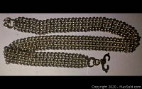 Full necklace showing the triple chain band construction and clasp rings at each end.