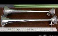 Two 25 inch Grover Products air horns placed side by side with ruler showing length