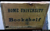 Front view of vintage wooden case marked 'HOME UNIVERSITY Bookshelf' in black text.