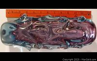 Top view of the art glass vase showing the swirling amethyst purple glass encased in blue glass, approximately 12 inches in length measured against a ruler.