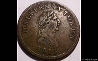 Obverse side of 1815 halfpenny trade token coin showing laurel wreath-adorned bust and text 'HALFPENNY TOKEN 1815'.