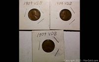 Three 1909 VDB Lincoln Wheat Cents mounted in cardboard 2x2 holders