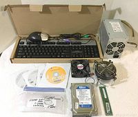 Full lot showing keyboard, mouse, power supply, hard drive, RAM, fan, heatsink fan, and software CDs