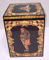 Full view of box with Cowardly Lion image and gold scrollwork on front side