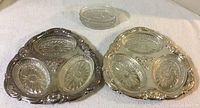 Two silver plated serving trays with three glass inserts each, plus three extra glass inserts on a white background