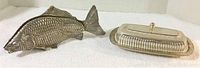 Photo showing both vintage fish menu holder and butter dish placed side by side on a white surface