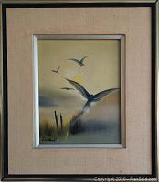 Framed vintage oil painting on canvas showing birds in flight with sun and grasses, signed Dumont in lower left