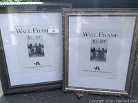 Two large matted wall frames side by side, one simple dark bordered 16x20 frame and one ornate 18x20 frame, both new in plastic.