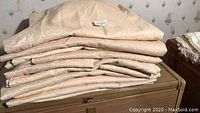 Stack of folded beige/tan drape panels
