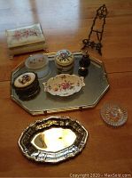 Full lot arranged on wooden surface showing all boxes, trays, stand and bottle.