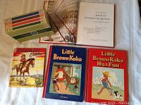 Overview of 7 books including children's Little Brown Koko books, Cowboy Eddie, and Readers Digest Teen Topics compilations alongside a large book on interior decoration.