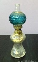 Full view of miniature hobnail oil lamp showing blue hobnail glass top, clear hobnail midsection and clear ribbed base