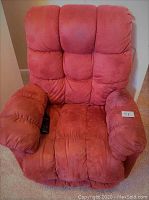 Front view of a red fabric Okin power lift recliner chair with a remote on the left armrest, showing cushioned seating, armrests, and backrest.