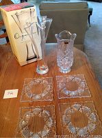 Photo showing all six items together: Lenox Organix vase with box, Noritake lead crystal vase, and four square EAPG glass plates arranged in front.