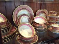 Overall display of full 40-piece china set on shelf