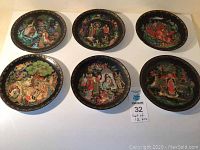 Six decorative plates arranged on white background showing different folklore scene designs.
