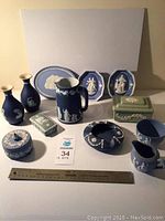 12 pieces Wedgewood and Escanada pottery items grouped on white background with measuring ruler