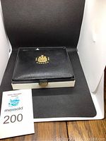 Closed black presentation case with gold Royal Canadian Mint logo