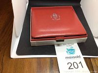 Red box with Royal Canadian Mint logo and Canada coat of arms embossed, housing the coin set.