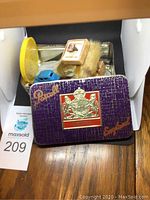 Pascal-themed metal tin containing assorted toys