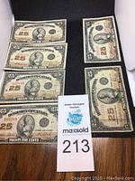 Six Dominion of Canada 25 cent banknotes dated 1923 laid out on a black surface showing front designs and text details.