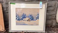 Full front view of framed winter landscape painting showing cabin, pine trees and snow